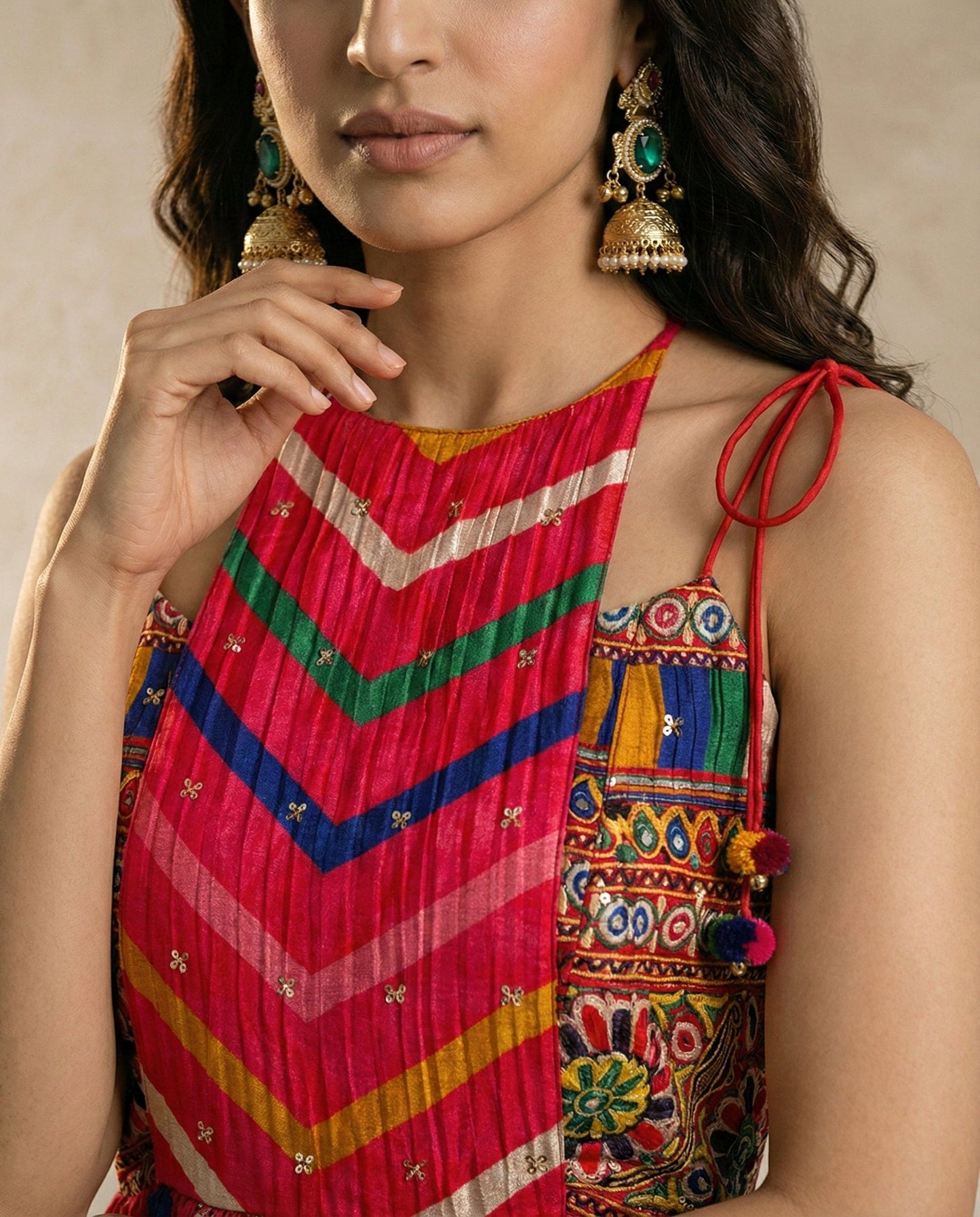 ZAVIYA red chevron leheriya set with printed hem border and pom-pom tassels, studio view.