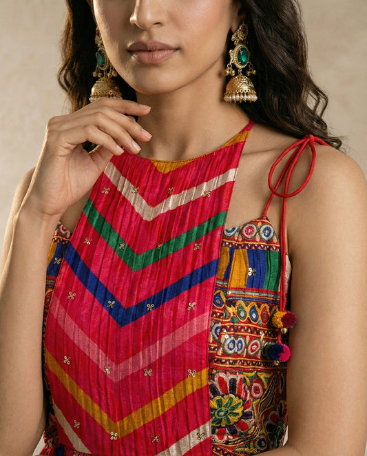 ZAVIYA red chevron leheriya set with printed hem border and pom-pom tassels, studio view.
