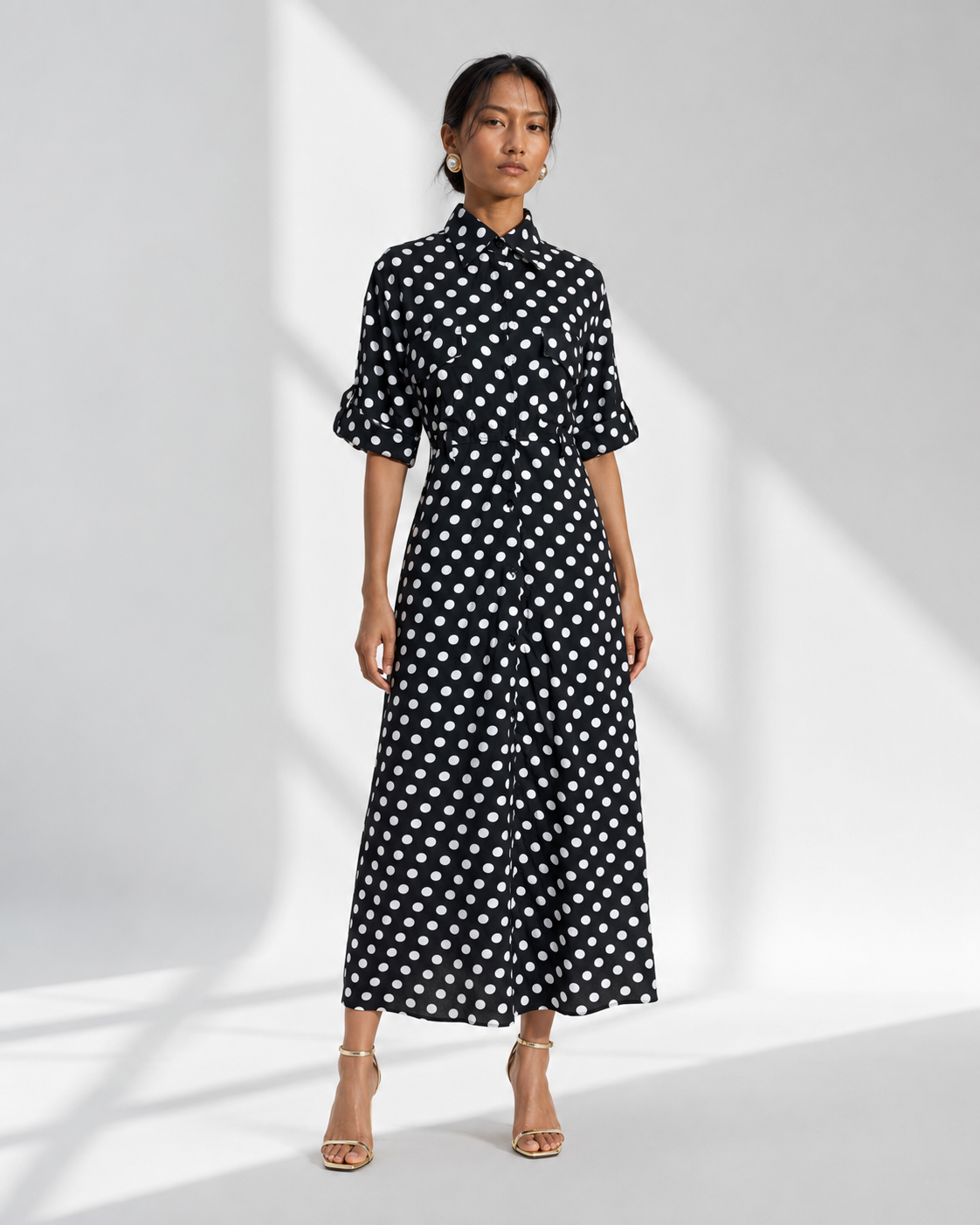 Neha Sharma Label SIMONE black polka dot crepe maxi shirt dress with collar, front view on model.