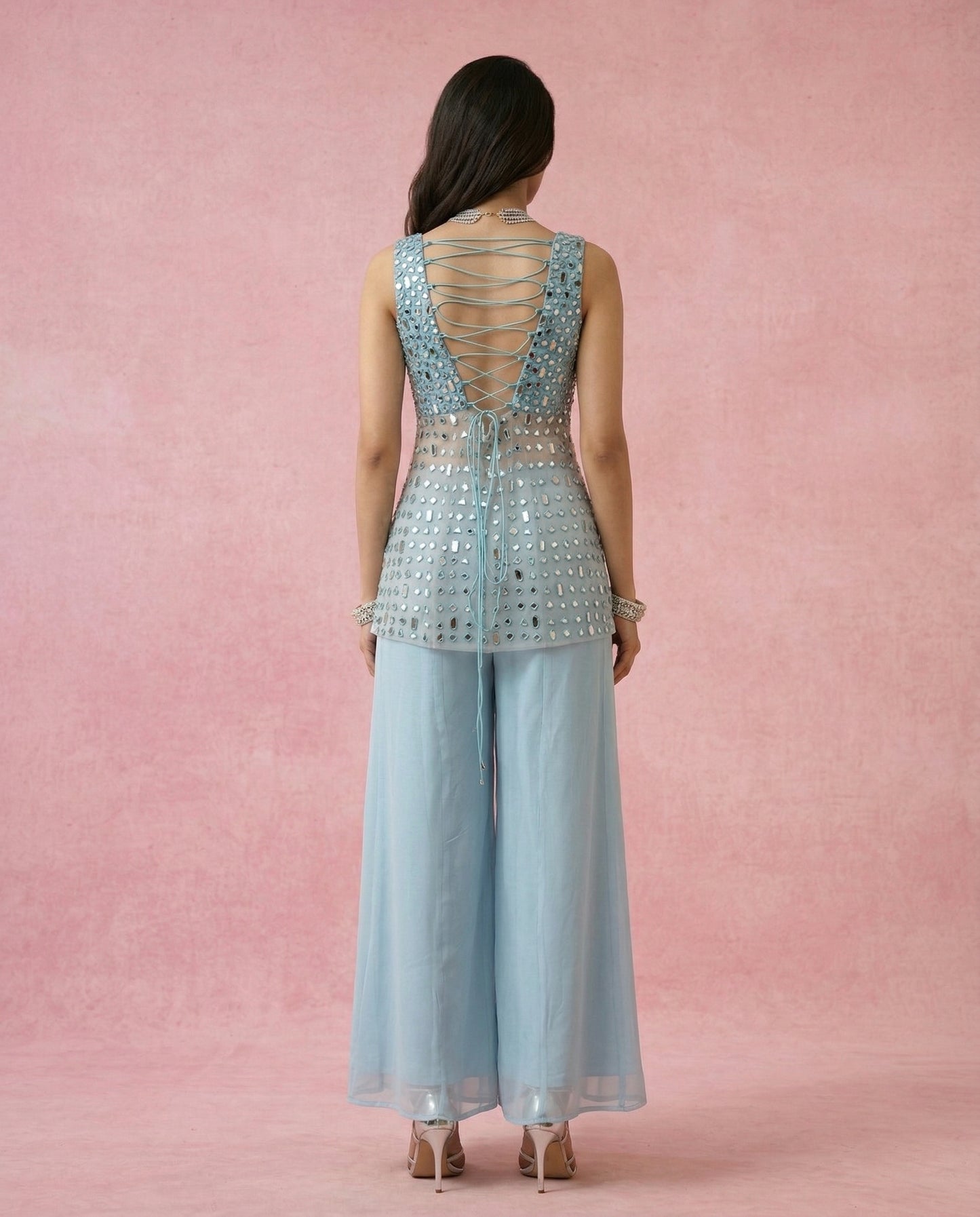 Criss-cross dori tie-up back with hanging tie tails on the MAHTAB powder blue mirror work kurta.