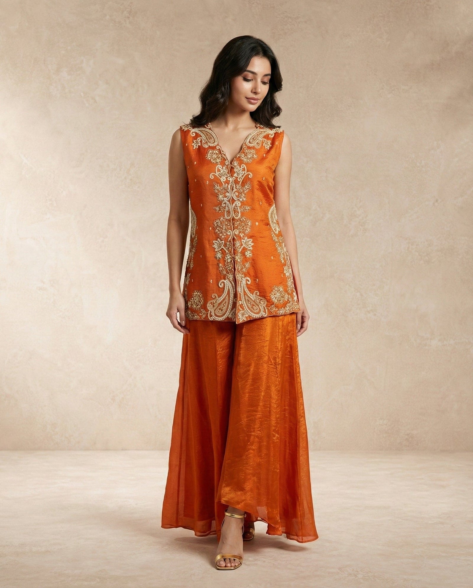 Neha Sharma Label SHAHNAZ rust silk sleeveless embroidered top with crushed silk wide-leg pants.