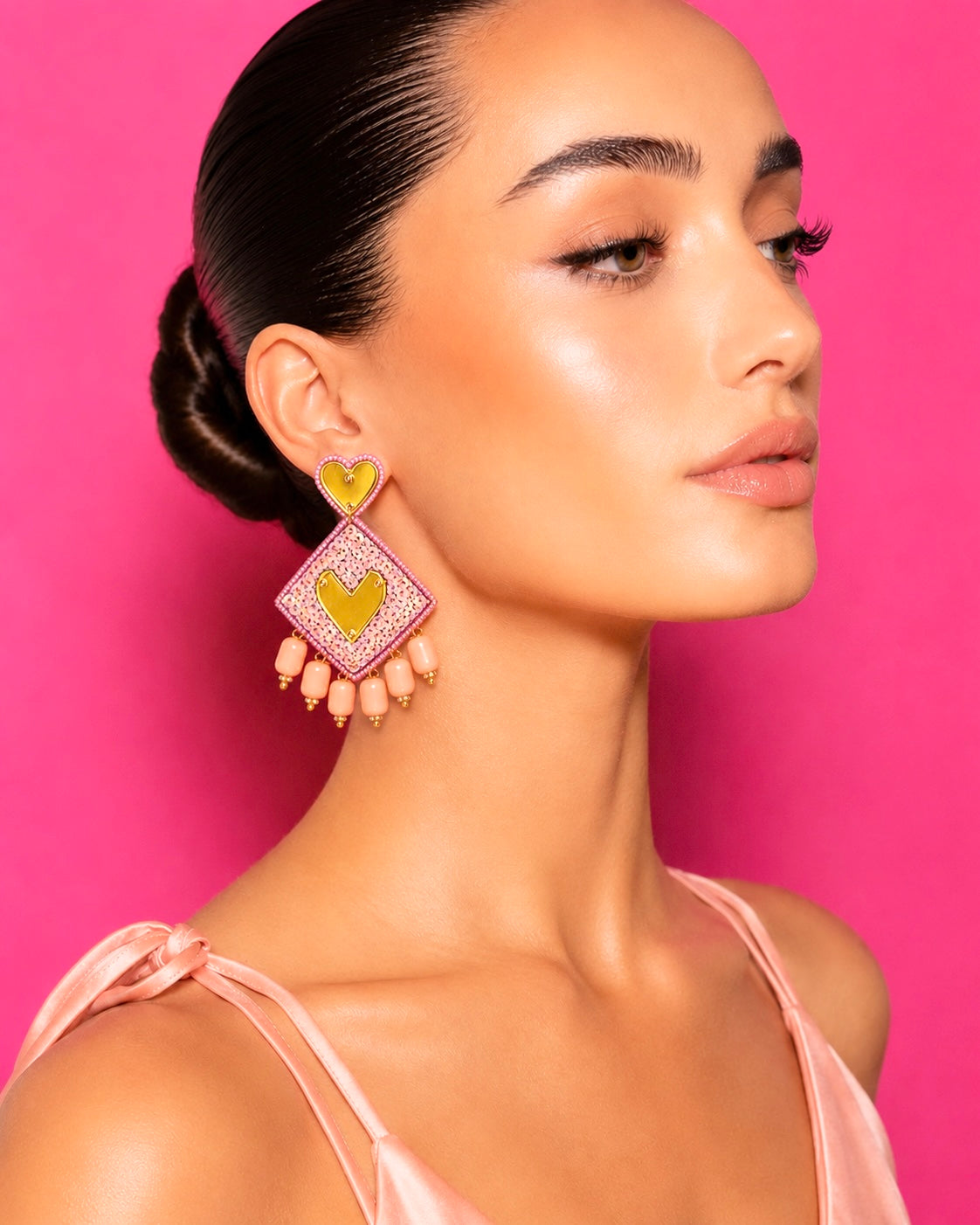Neha Sharma Label Peach Bonbon sequin drop earrings with gold-tone hearts and peach bead drops.