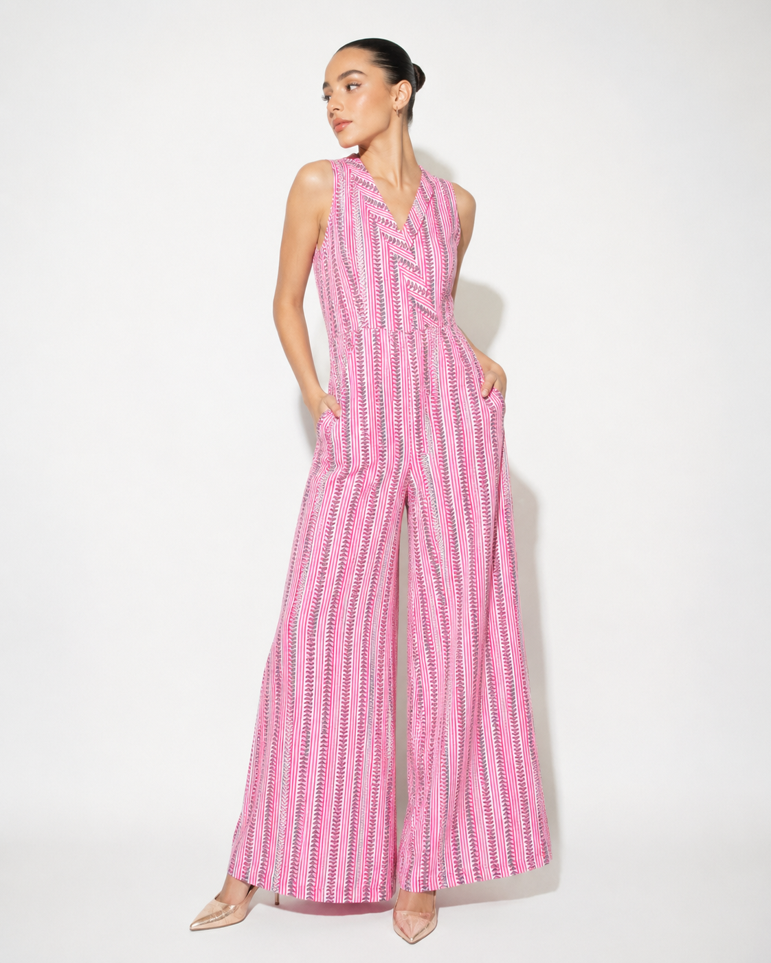 Model wearing DAHLIA pink stripe print cotton jumpsuit by Neha Sharma Label.