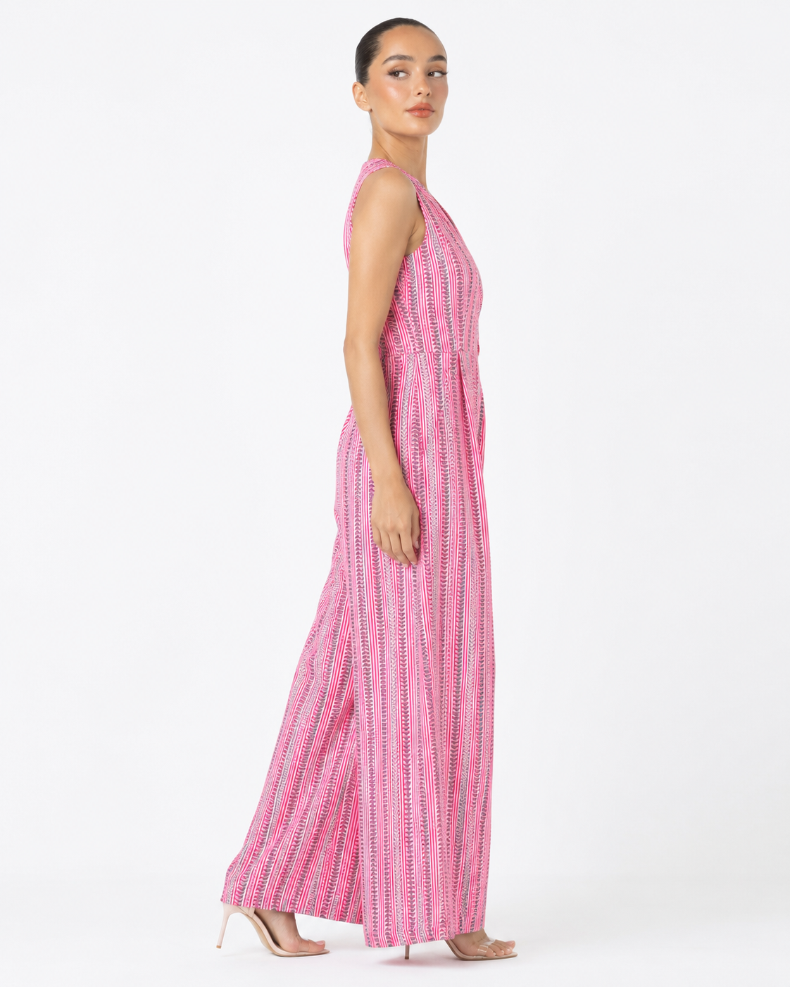 Side view of the DAHLIA pink cotton jumpsuit with V neckline and wide legs.