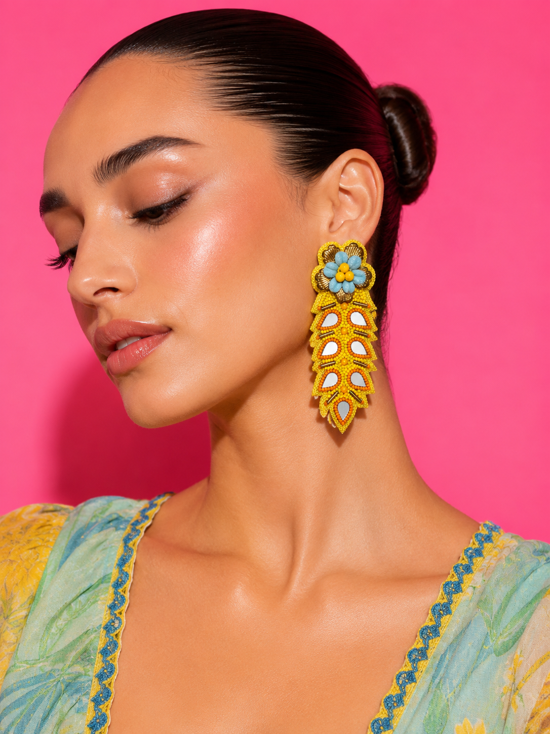 Neha Sharma Label Mango Pop yellow leaf drop earrings with orange-rimmed mirror teardrops.