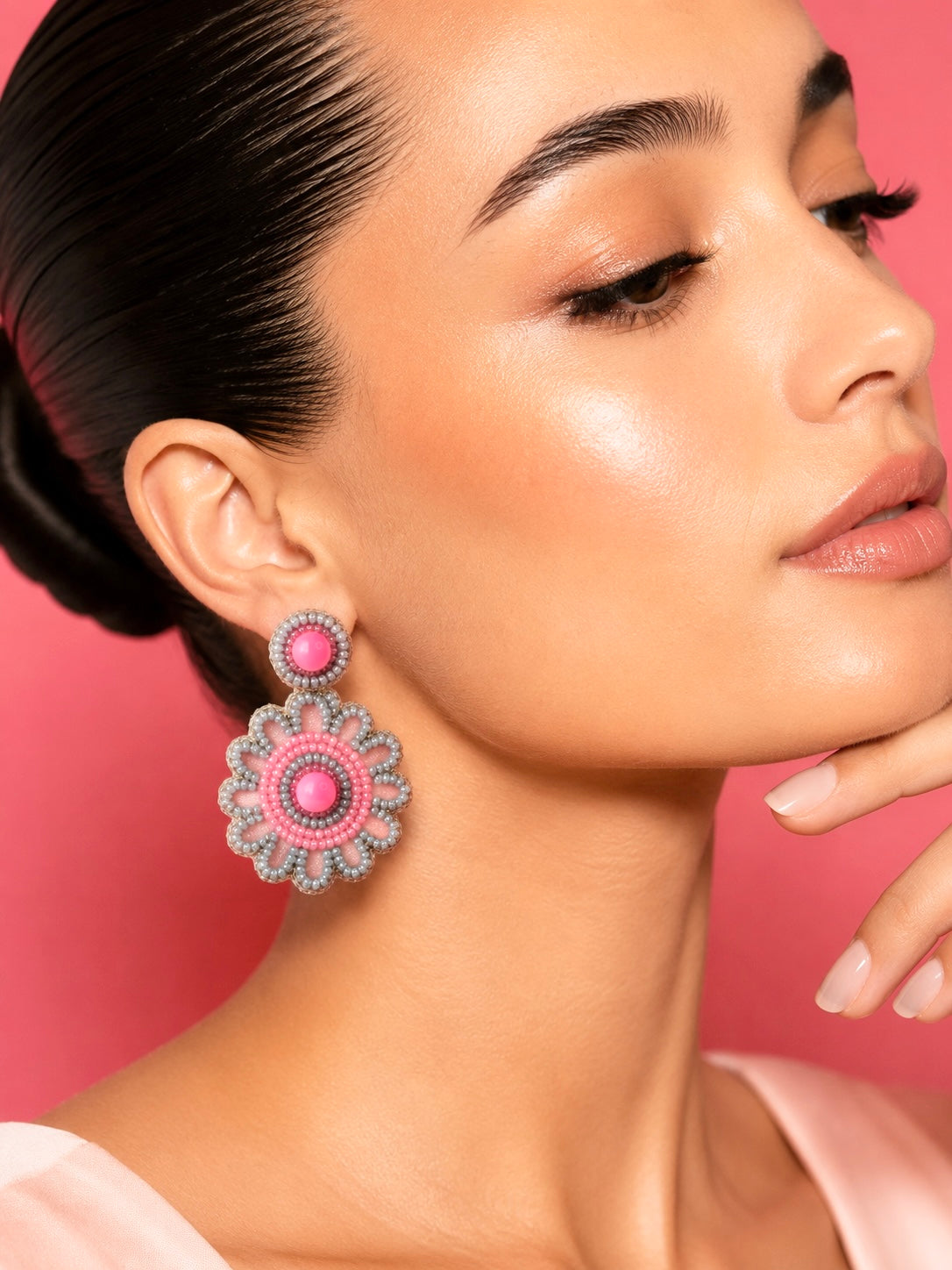 Model wearing CRANBERRY POP pink and lilac beaded flower drop earrings by Neha Sharma Label.