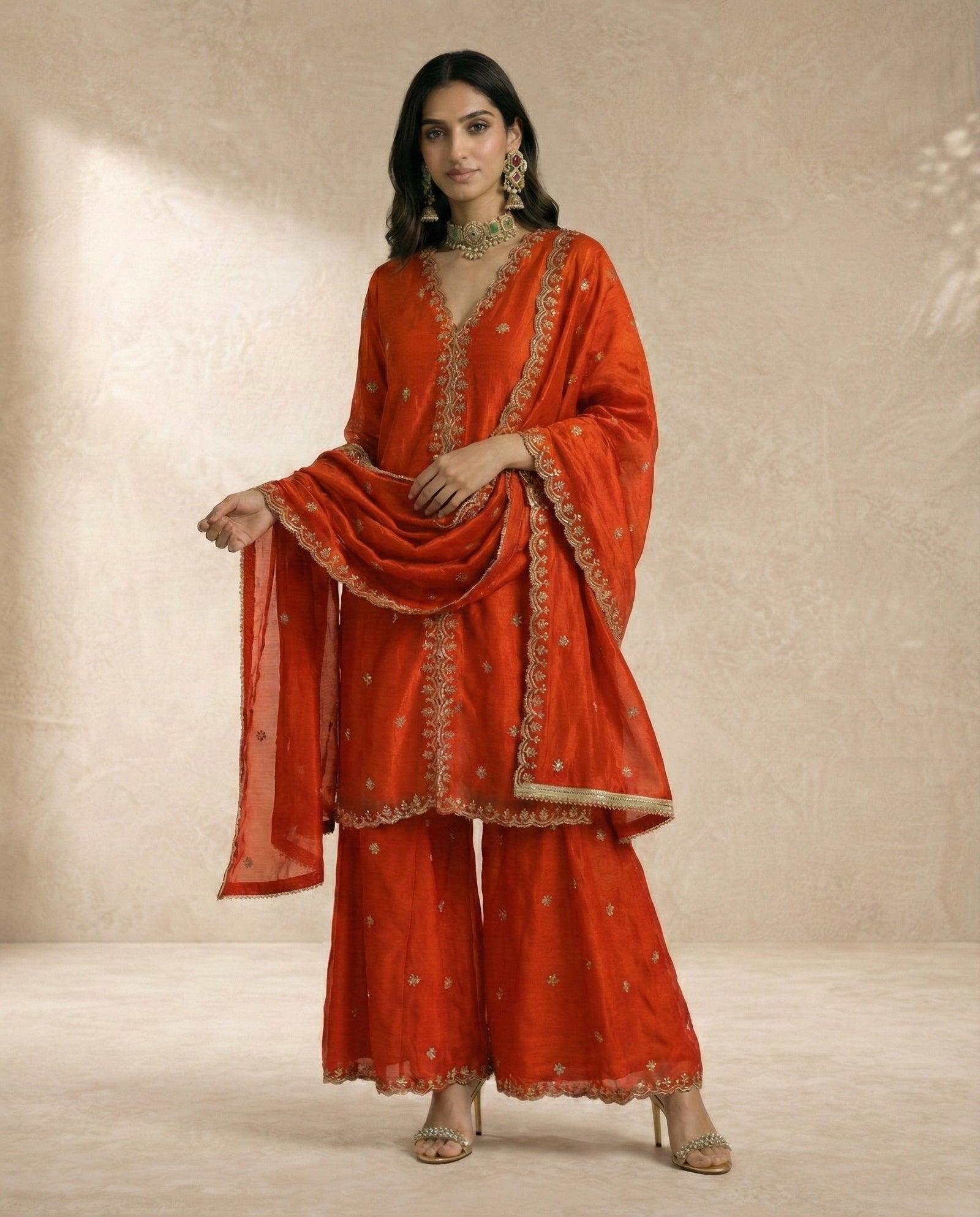 Neha Sharma Label SAMARA vermilion crushed silk kurta sharara set with gold sequin embroidery.