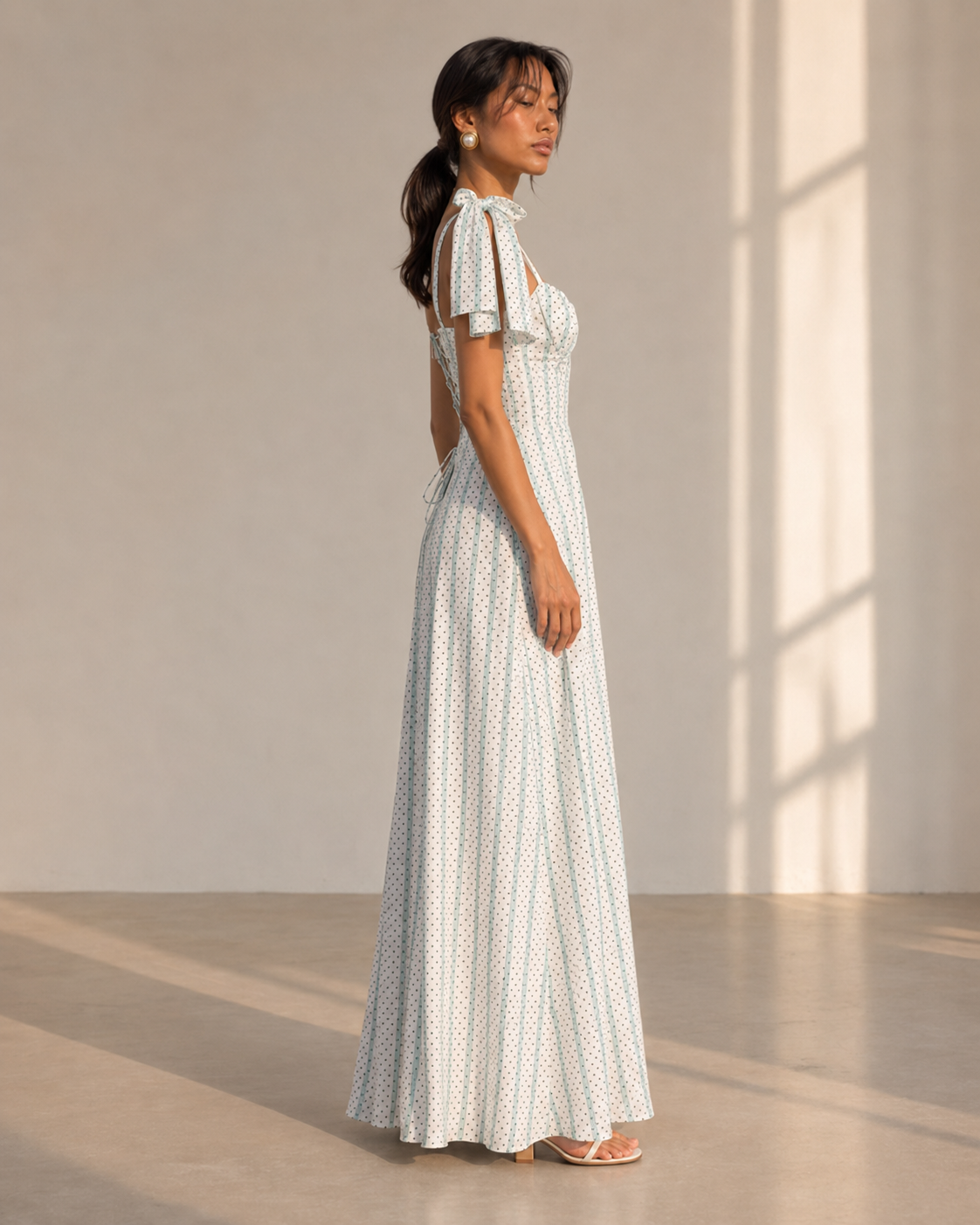 SYLVIE white dot stripe maxi dress with corset-seamed sweetheart bodice and tie-shoulder bows.