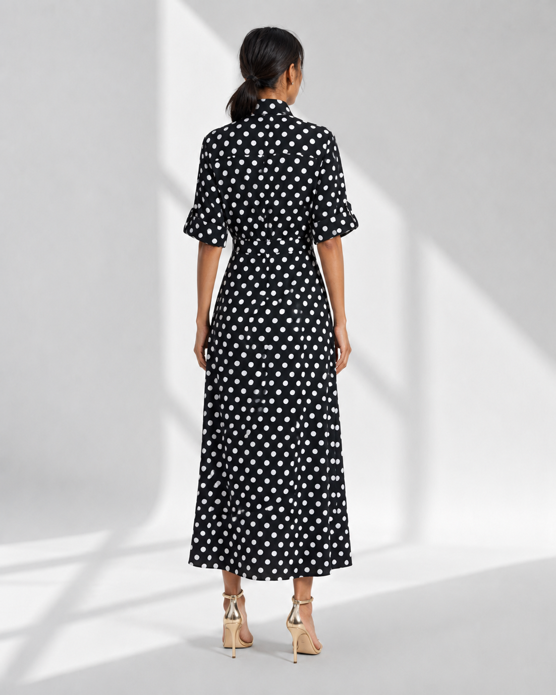 Back view of the SIMONE polka dot shirt dress showing the yoke and gathered A-line skirt.