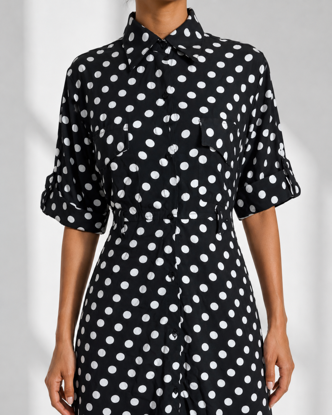 Close view of the pointed collar, flap chest pocket and button placket on the SIMONE dress.