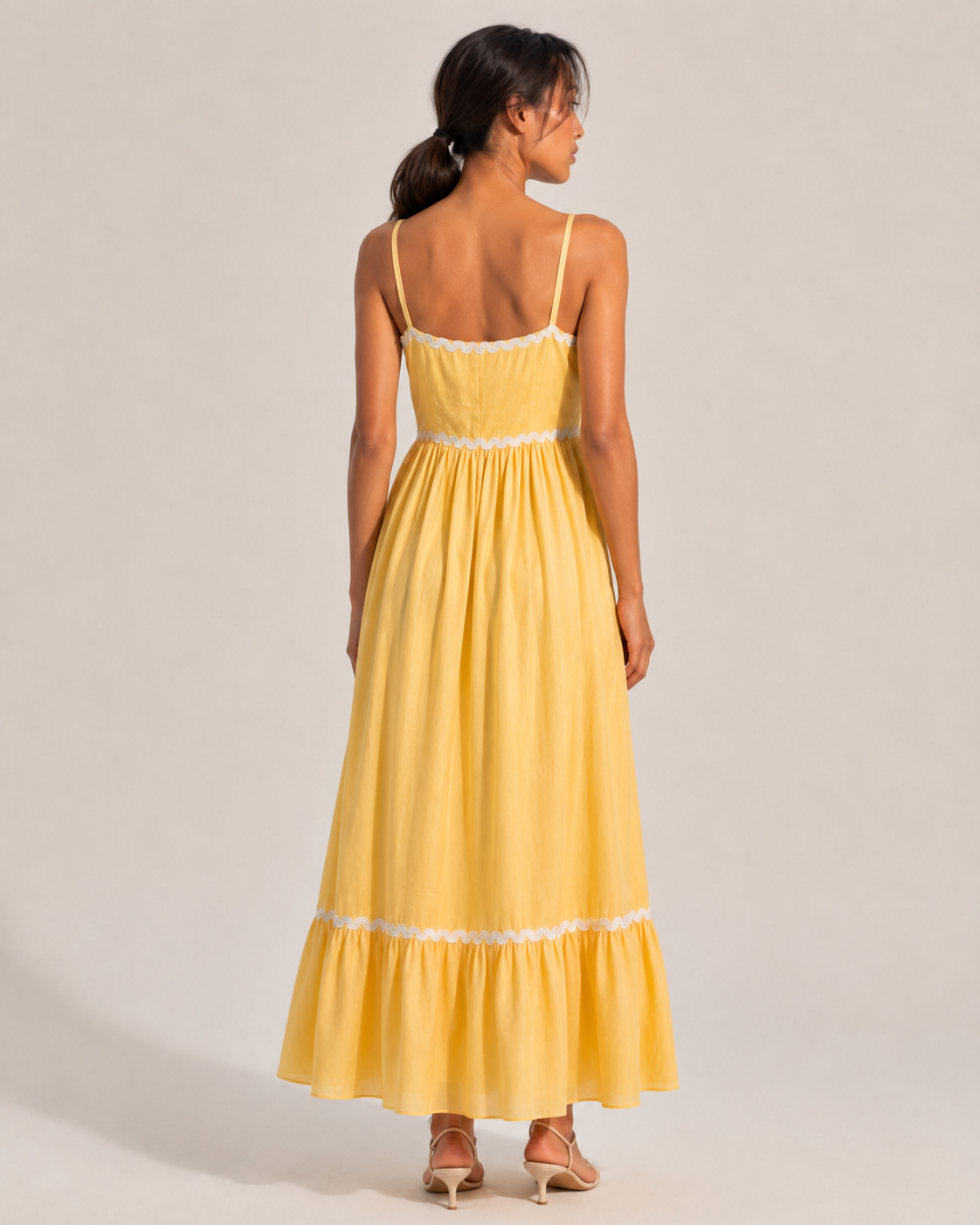 JUNE butter yellow tiered maxi dress showing the gathered skirt and flounce hem.