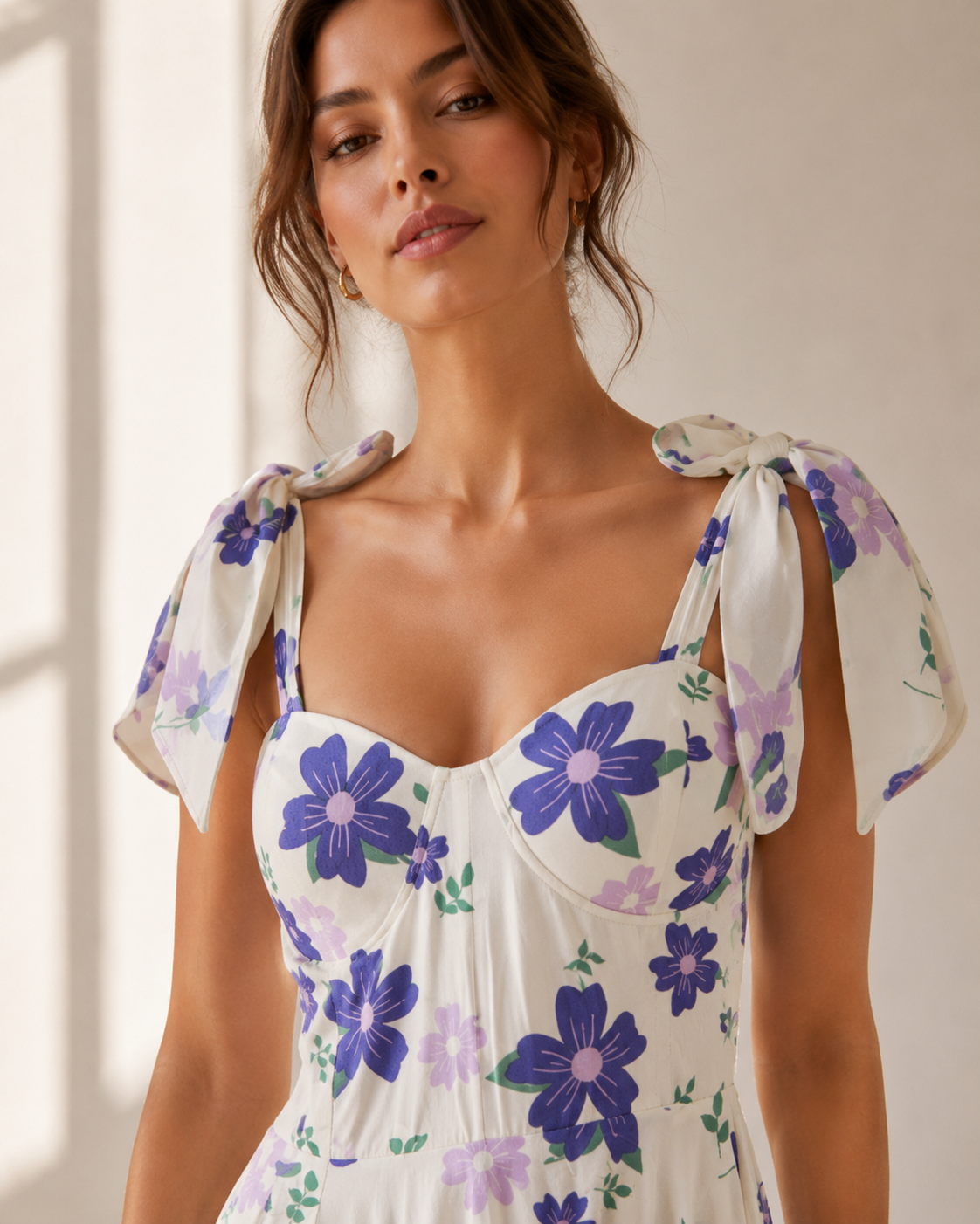 Detail of the violet blooms and bow-tied shoulder on the DELPHINE floral maxi dress.