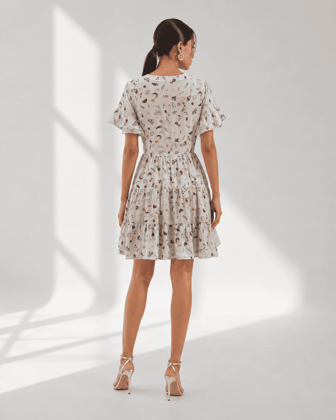 ELORA ivory doodle print mini dress with ruffle edge flutter sleeves by Neha Sharma Label