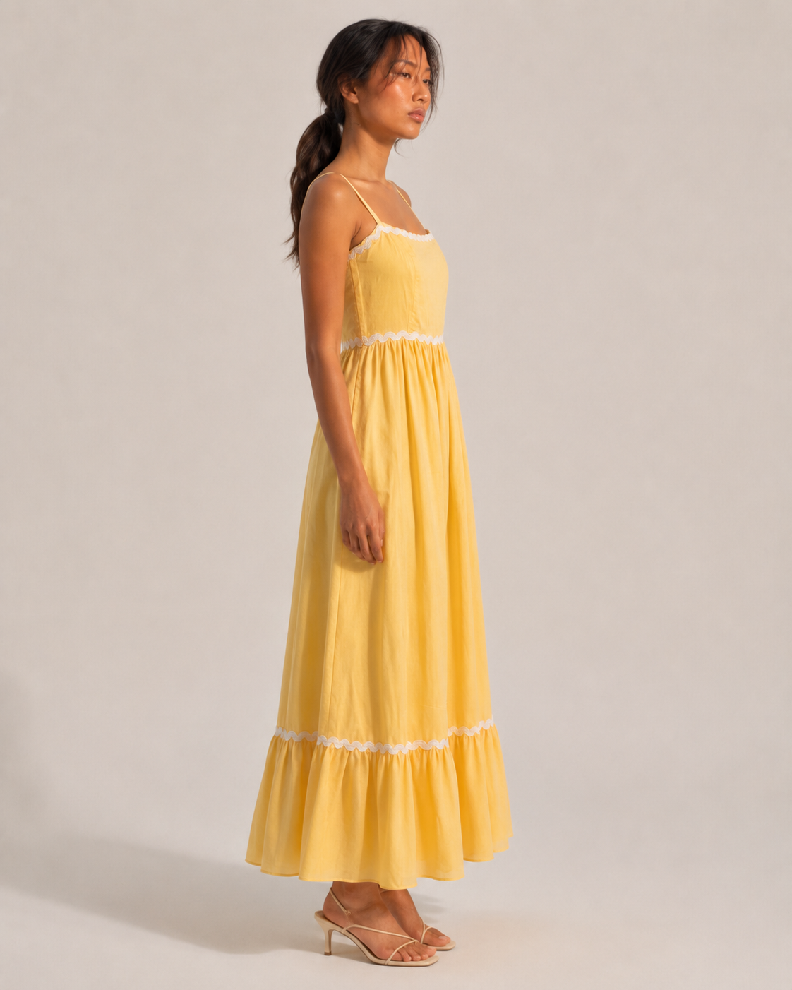 JUNE butter yellow maxi dress with fitted bodice and white scalloped lace trim.