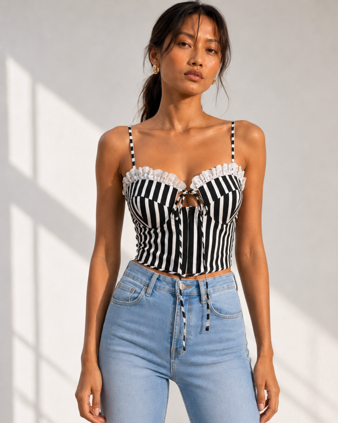 Model wearing LOLA black and white striped bustier crop top by Neha Sharma Label.