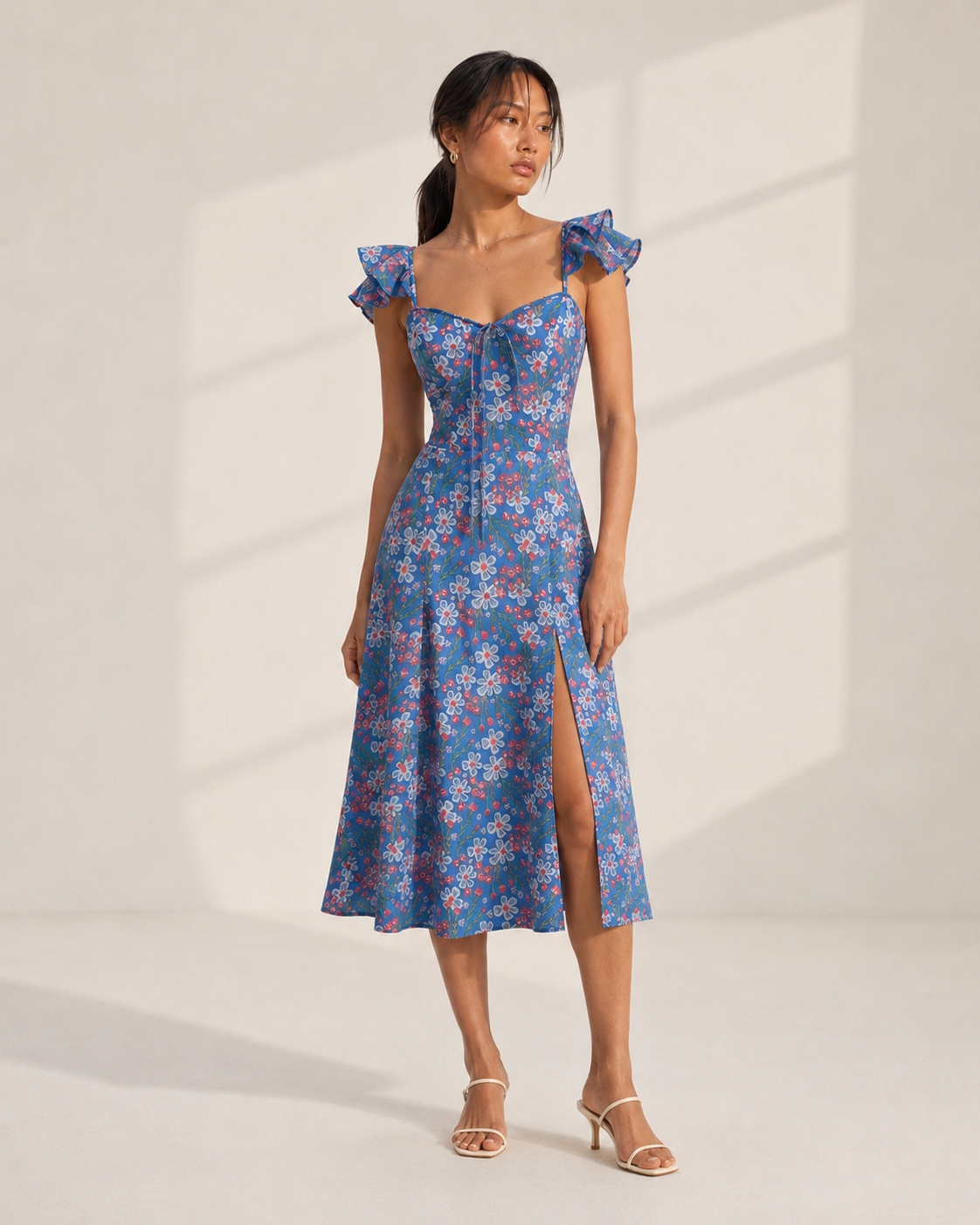 Model wearing ROMY blue floral print midi dress with ruffle straps by Neha Sharma Label.