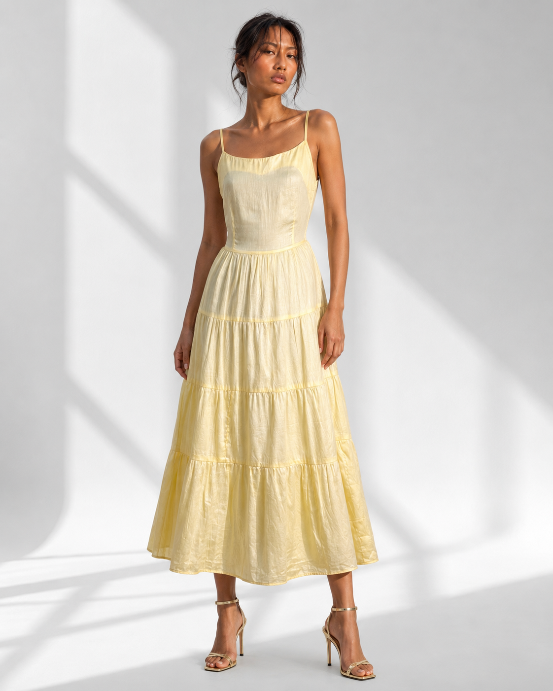 Neha Sharma Label SUNNIVA butter yellow tiered cotton sundress with spaghetti straps, front view.