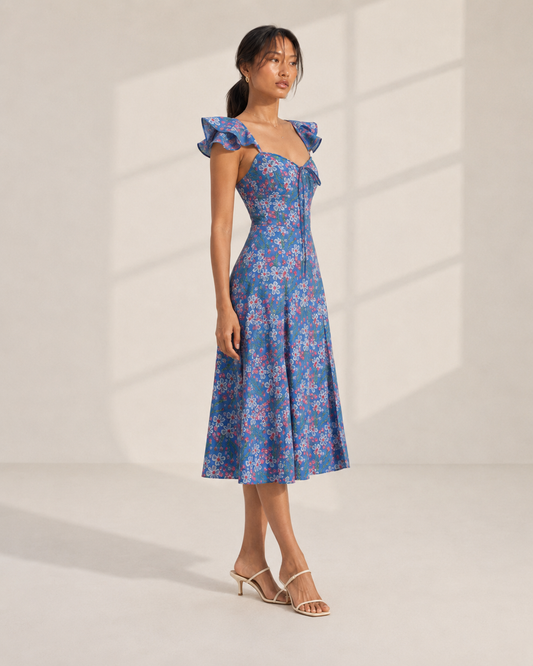 ROMY blue floral print midi dress showing the A-line skirt and front leg slit.