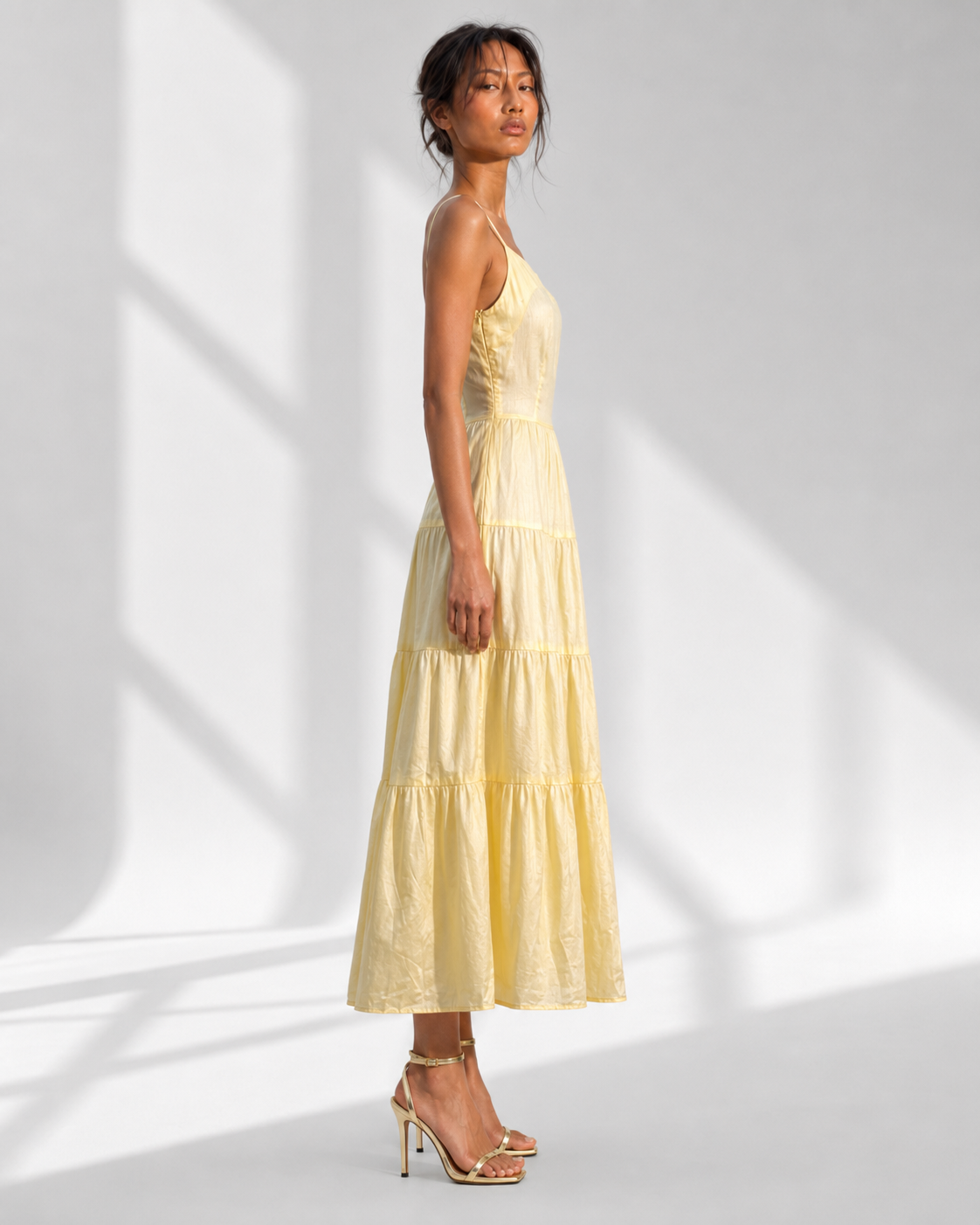 SUNNIVA butter yellow sundress in profile, four gathered tiers falling to the ankle.