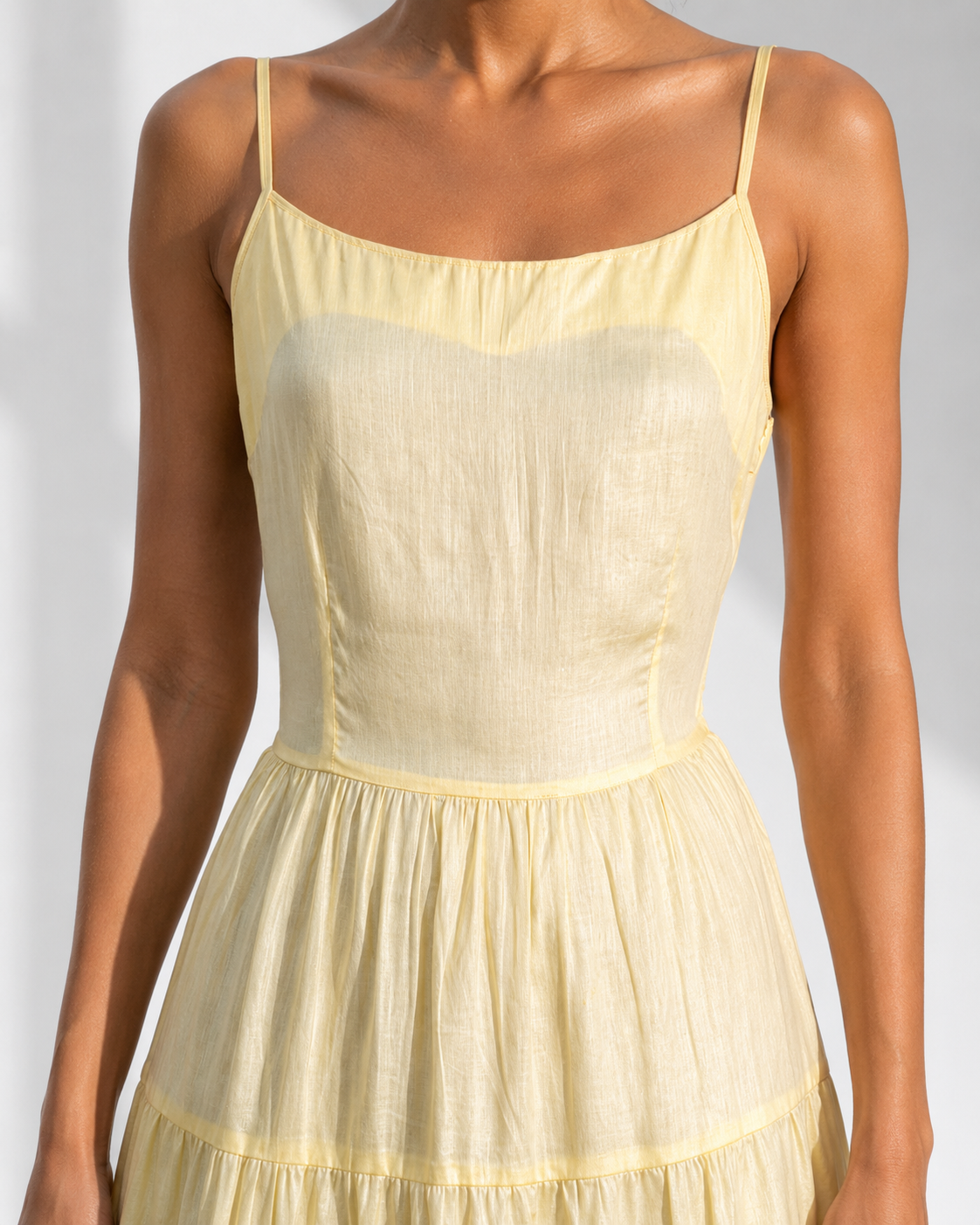 Close view of the sheer sweetheart bodice detail on the SUNNIVA butter yellow sundress.