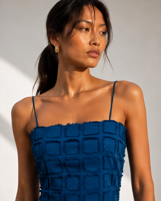 Detail of the fringed grid texture and slim straps on the CLEO cobalt blue mini dress.