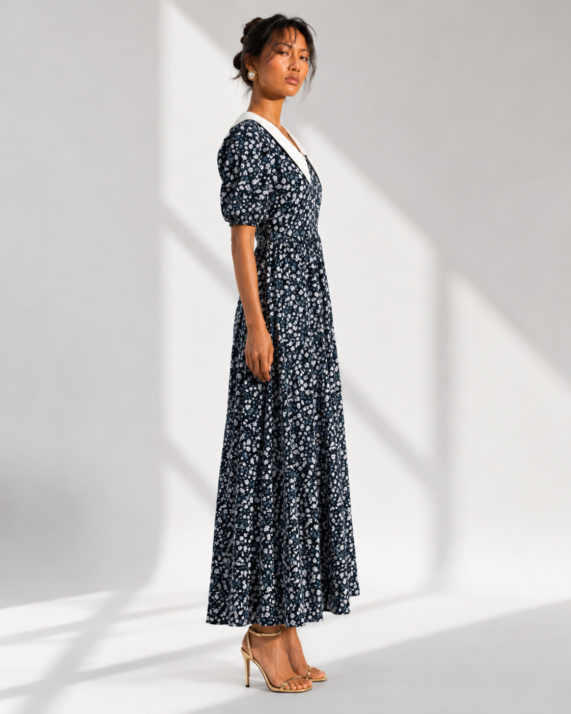 EULALIE navy floral contrast collar maxi dress in profile with short puff sleeves.