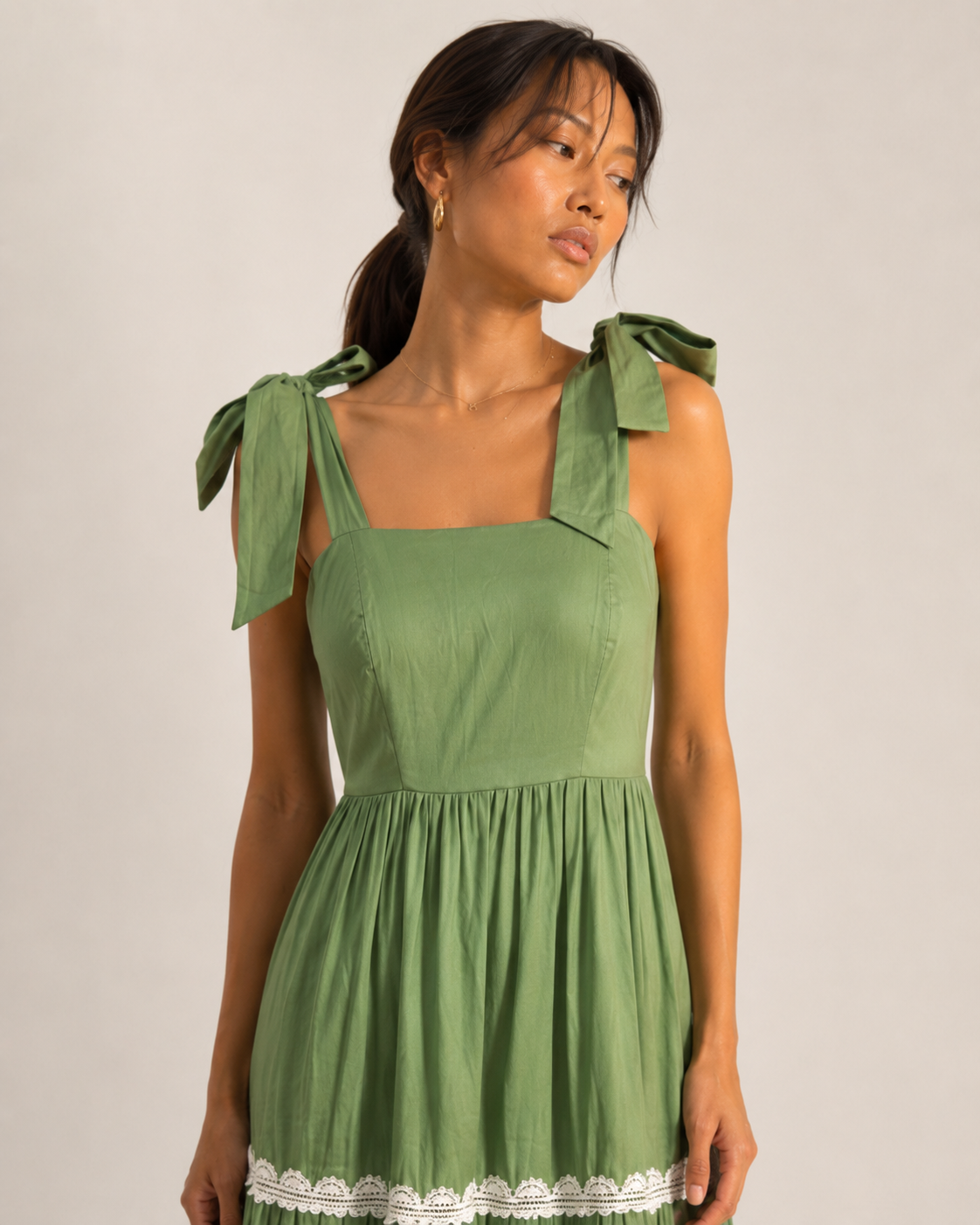 Detail of the white lace insertion bands on the MAEVE green tiered skirt.