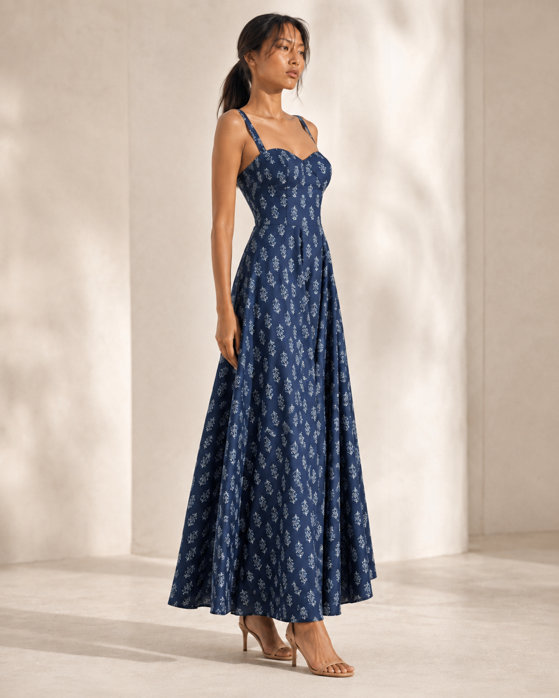 Back view of the AUDREY navy buti print dress showing centre-back zip and pleated skirt.
