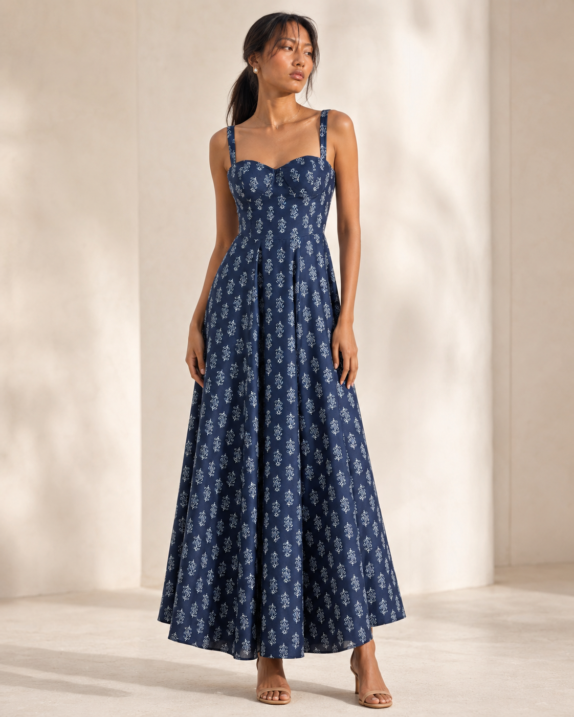 Model wearing AUDREY navy botanical print bustier maxi dress by Neha Sharma Label.