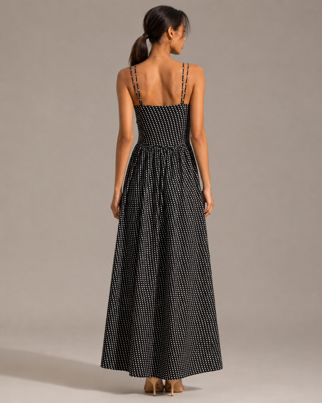 Back view of the NOVA black polka dot maxi dress showing double straps and gathered skirt.