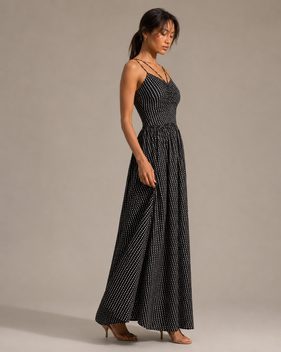 NOVA black pin-dot maxi dress with ruched pointed bodice and criss-cross strap detail.