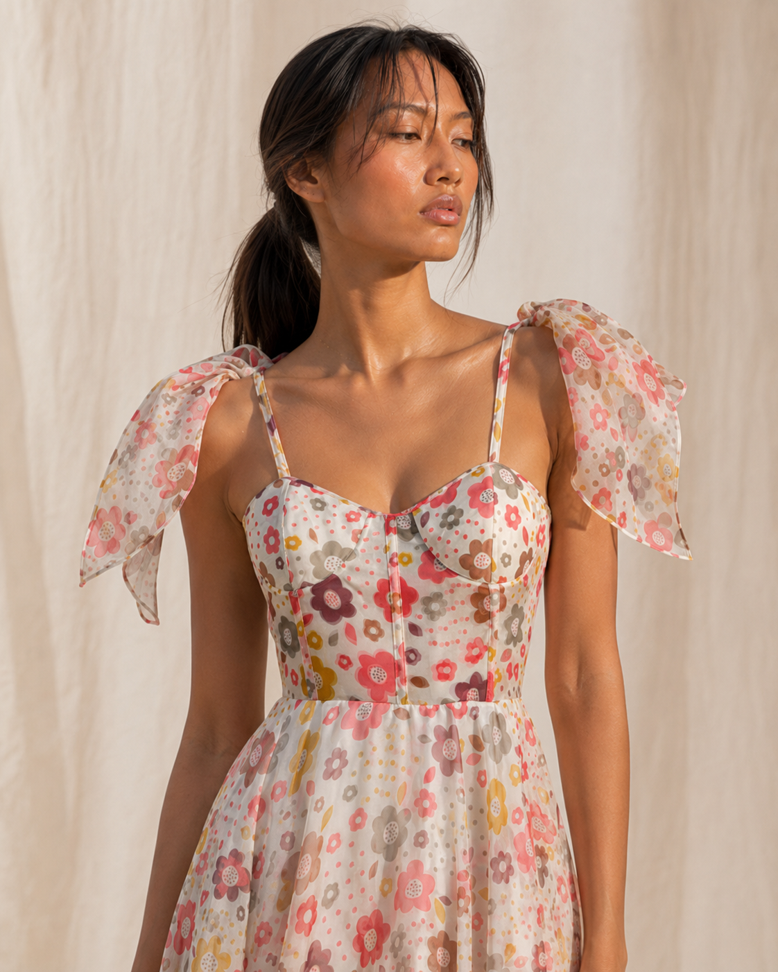 Detail of the coral, mustard and mauve retro floral print and bustier seams on PALOMA.