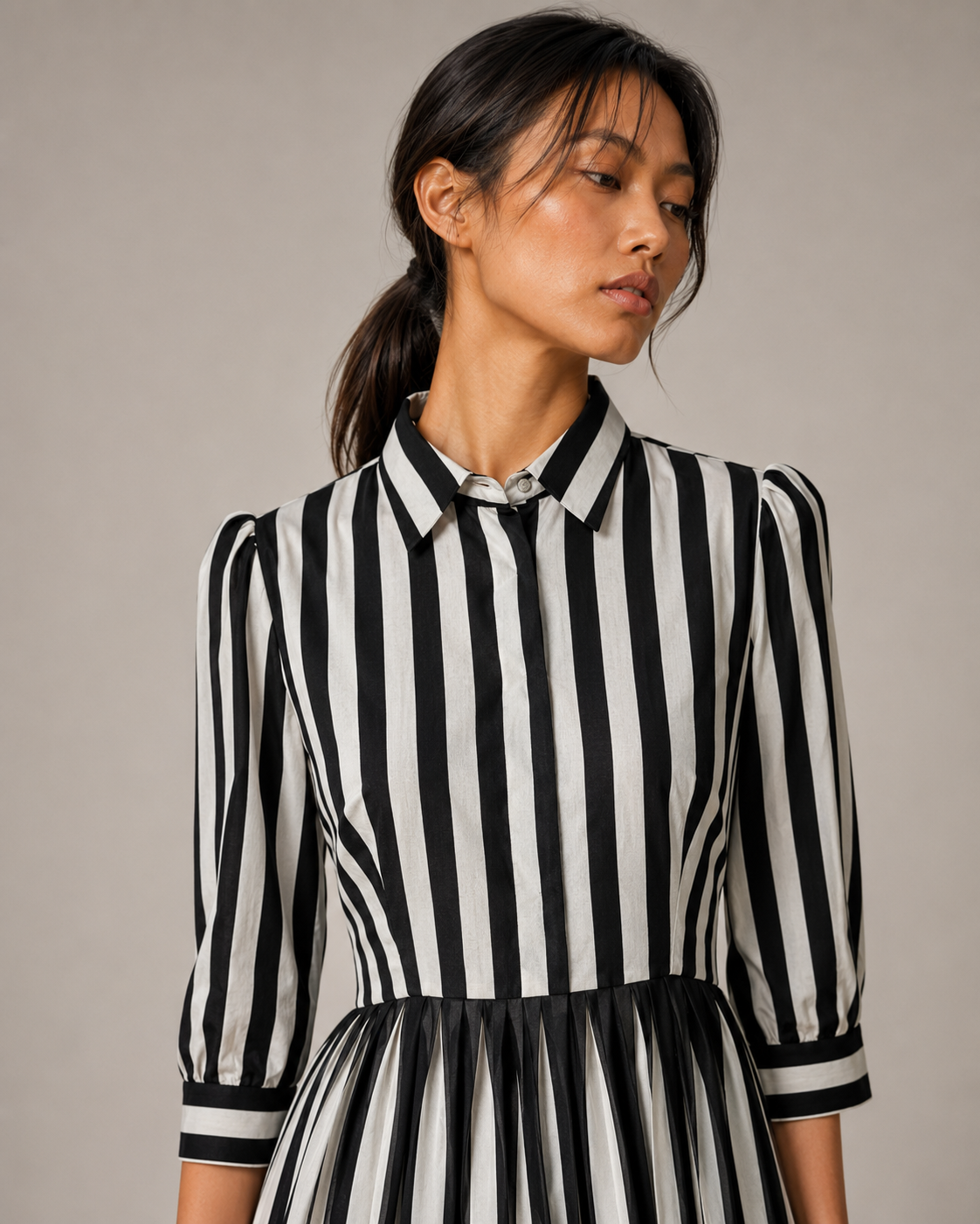Detail of the black and cream stripes and buttoned contrast cuffs on GRETA.