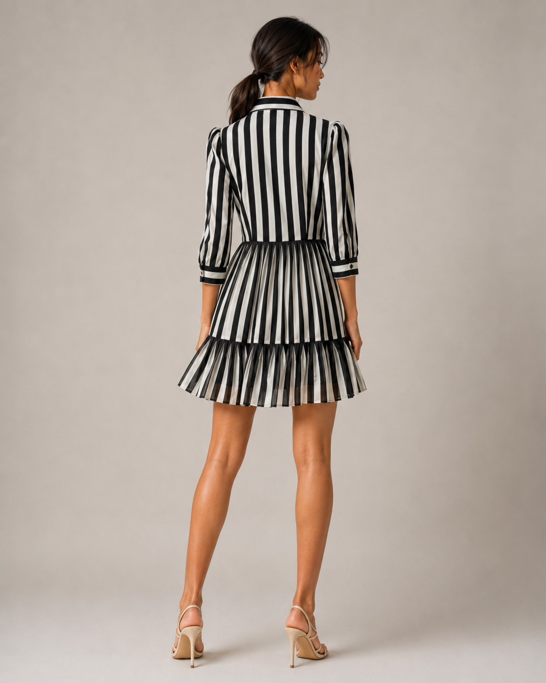 Back view of the GRETA striped mini shirtdress showing the tiered flounce hem.