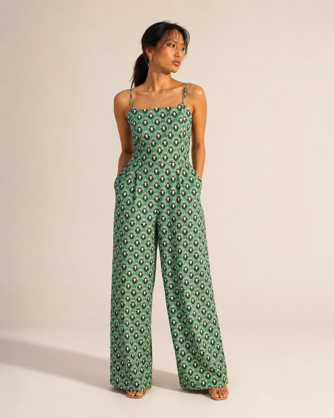 Model wearing WREN green teardrop print wide-leg jumpsuit by Neha Sharma Label.