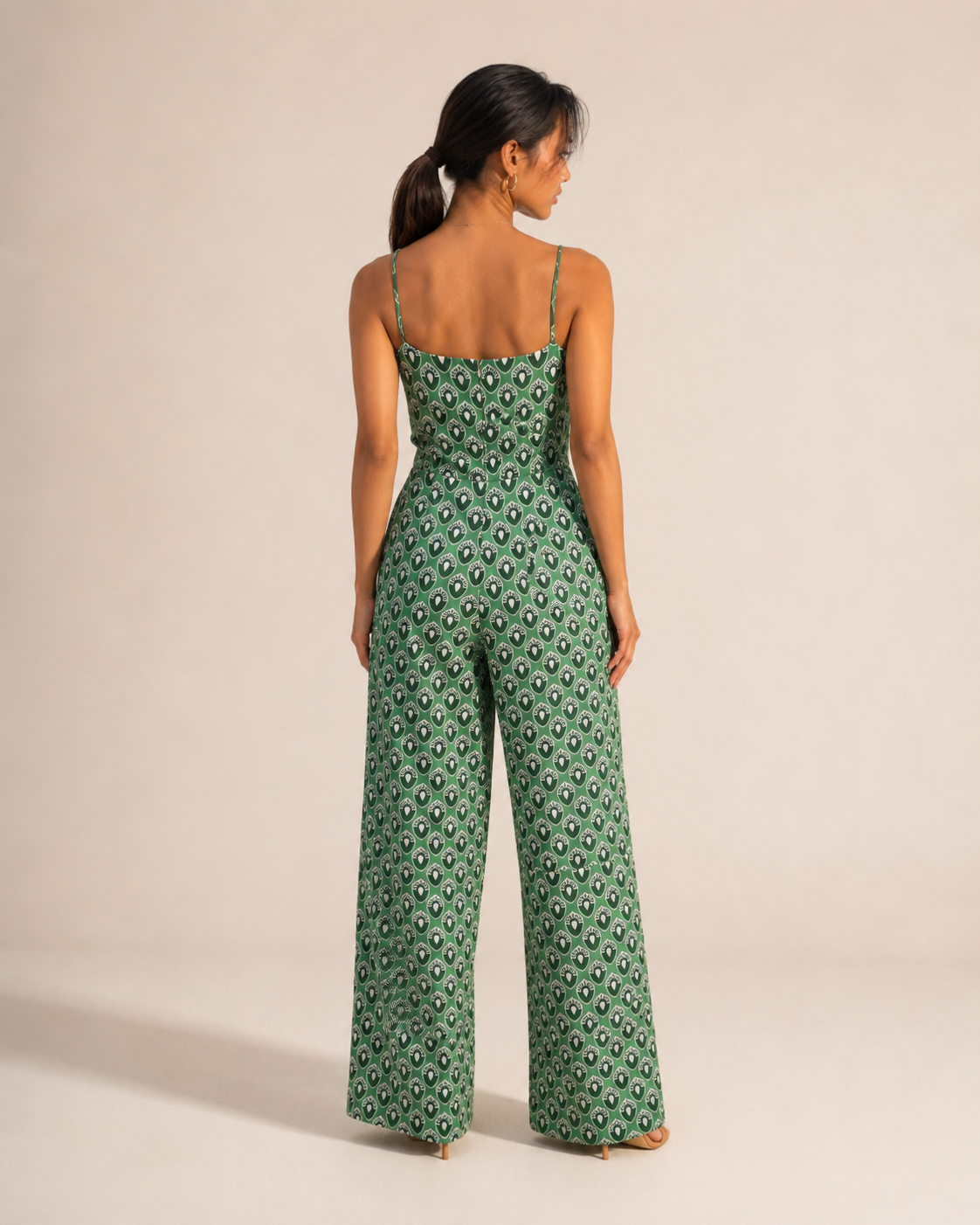 Back view of the WREN green teardrop print jumpsuit showing the wide legs.