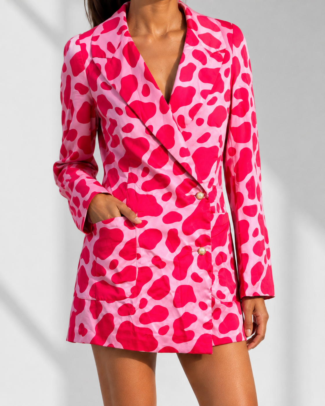 Close view of the pearl-effect buttons, lapels and patch pockets on the FRANCA blazer dress.