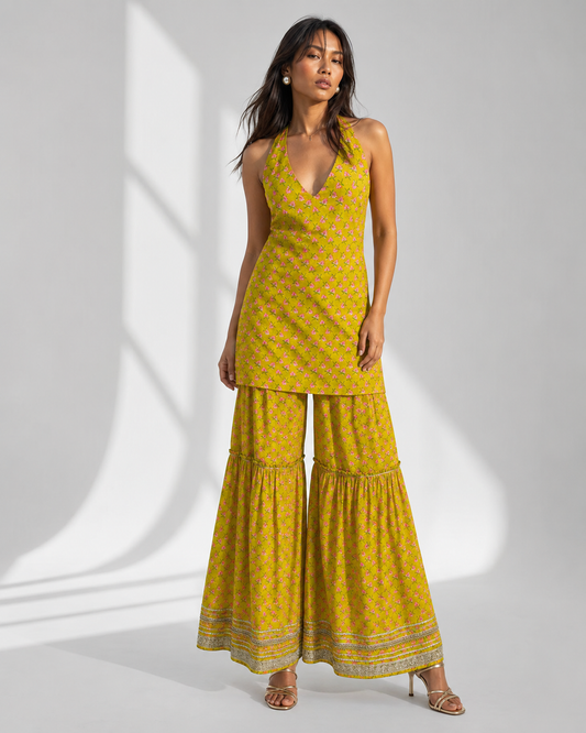 AVIRA mustard floral print gharara set with halter kurti by Neha Sharma Label