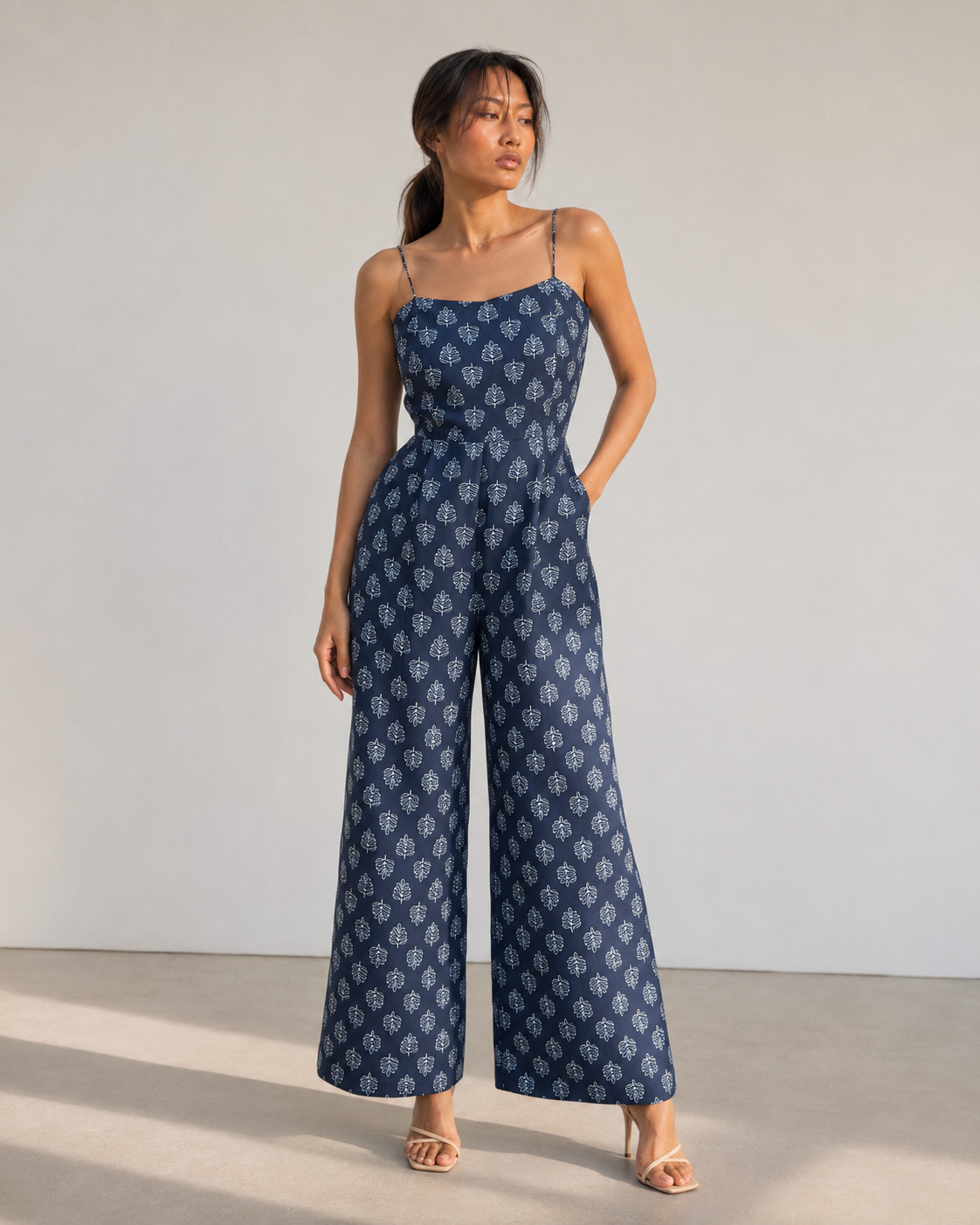 Neha Sharma Label IRIS navy botanical print wide-leg cotton jumpsuit, front view.