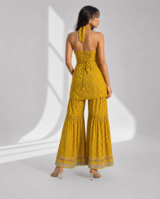 AVIRA mustard halter kurti with criss-cross tie-up back worn with matching gharara by Neha Sharma Label