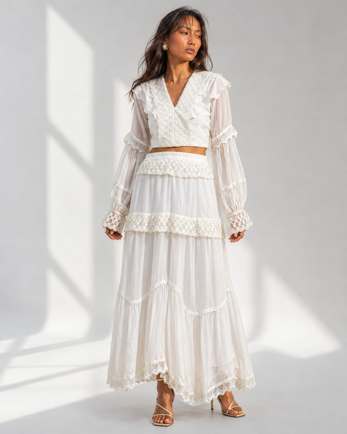 Neha Sharma Label MORWENNA ivory lace trim crop top and tiered maxi skirt set, front view on model.