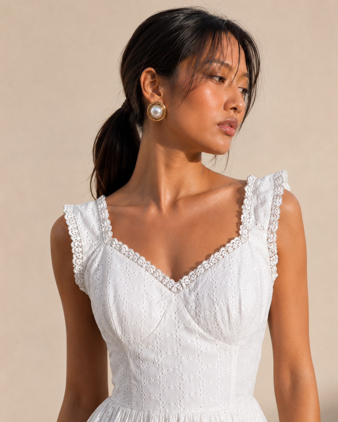 Detail of the broderie eyelet fabric and scalloped lace trim on the ALBA mini dress.