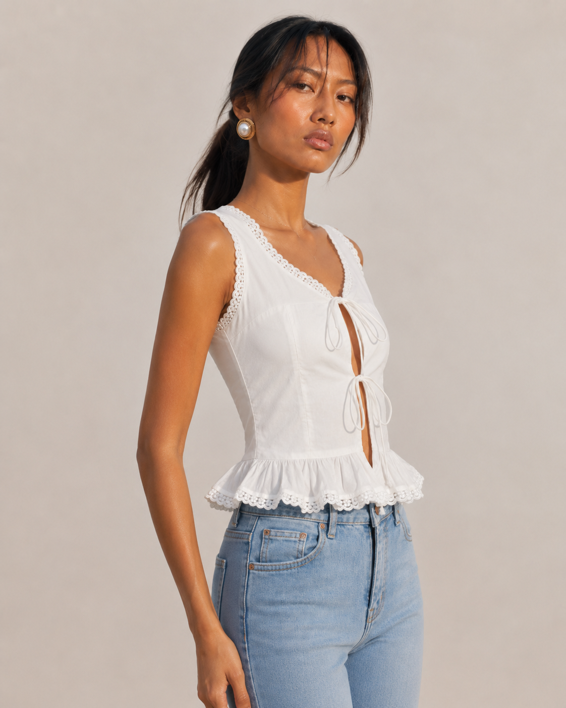 MARGOT white sleeveless top with lace-trimmed scoop neck and double tie-front bows.