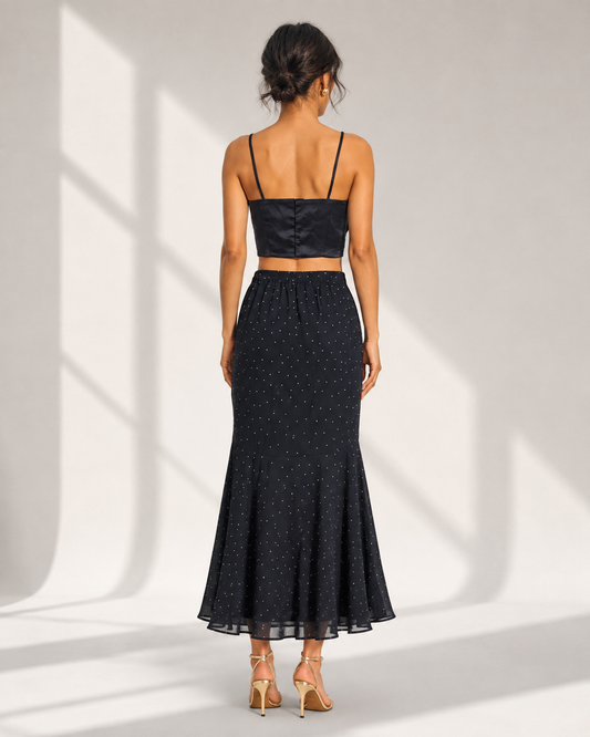 Back view of the FIAMMETTA black co-ord showing the fitted cami back and elasticated skirt waist.