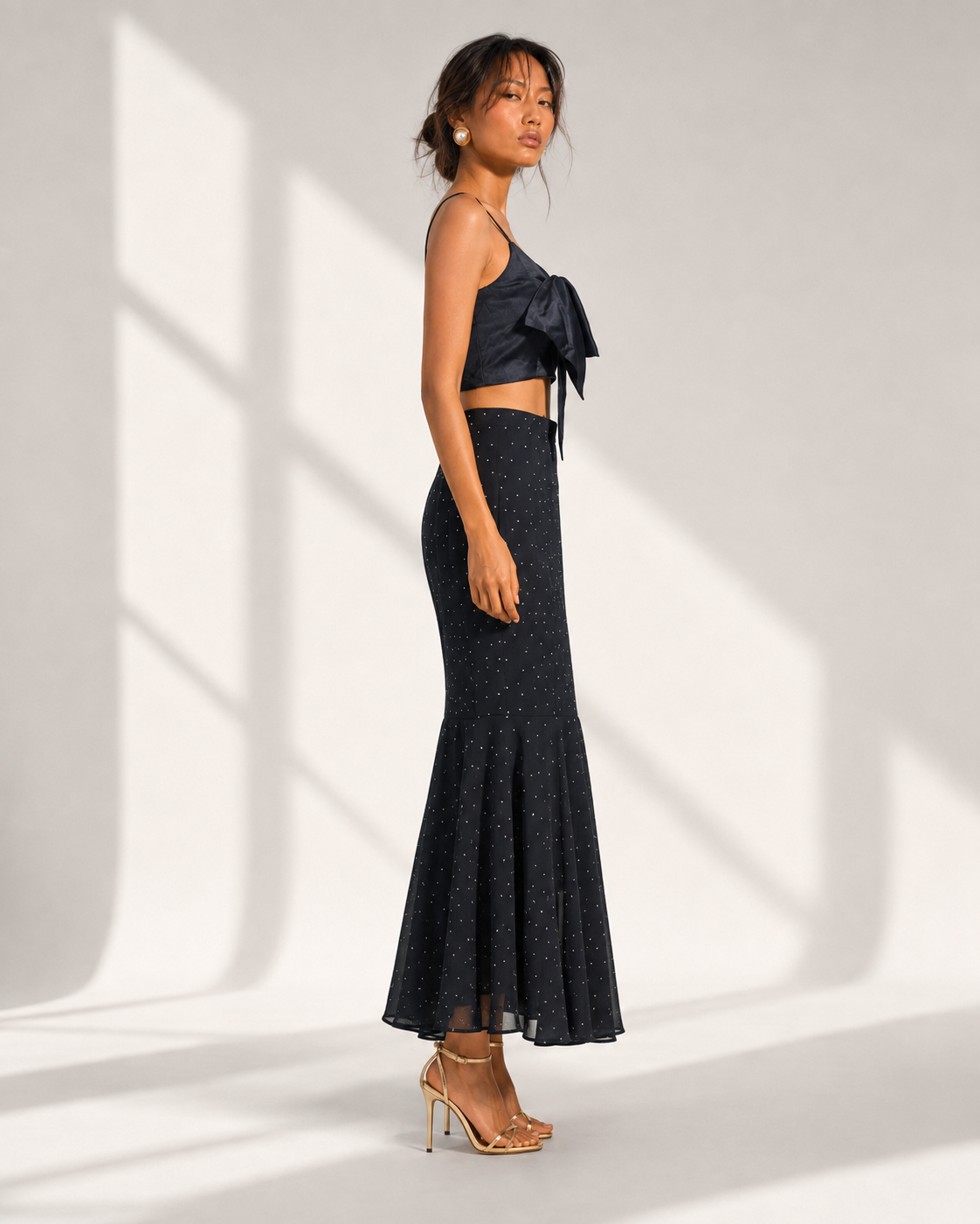 FIAMMETTA black bow top and micro dot mermaid skirt set in profile.