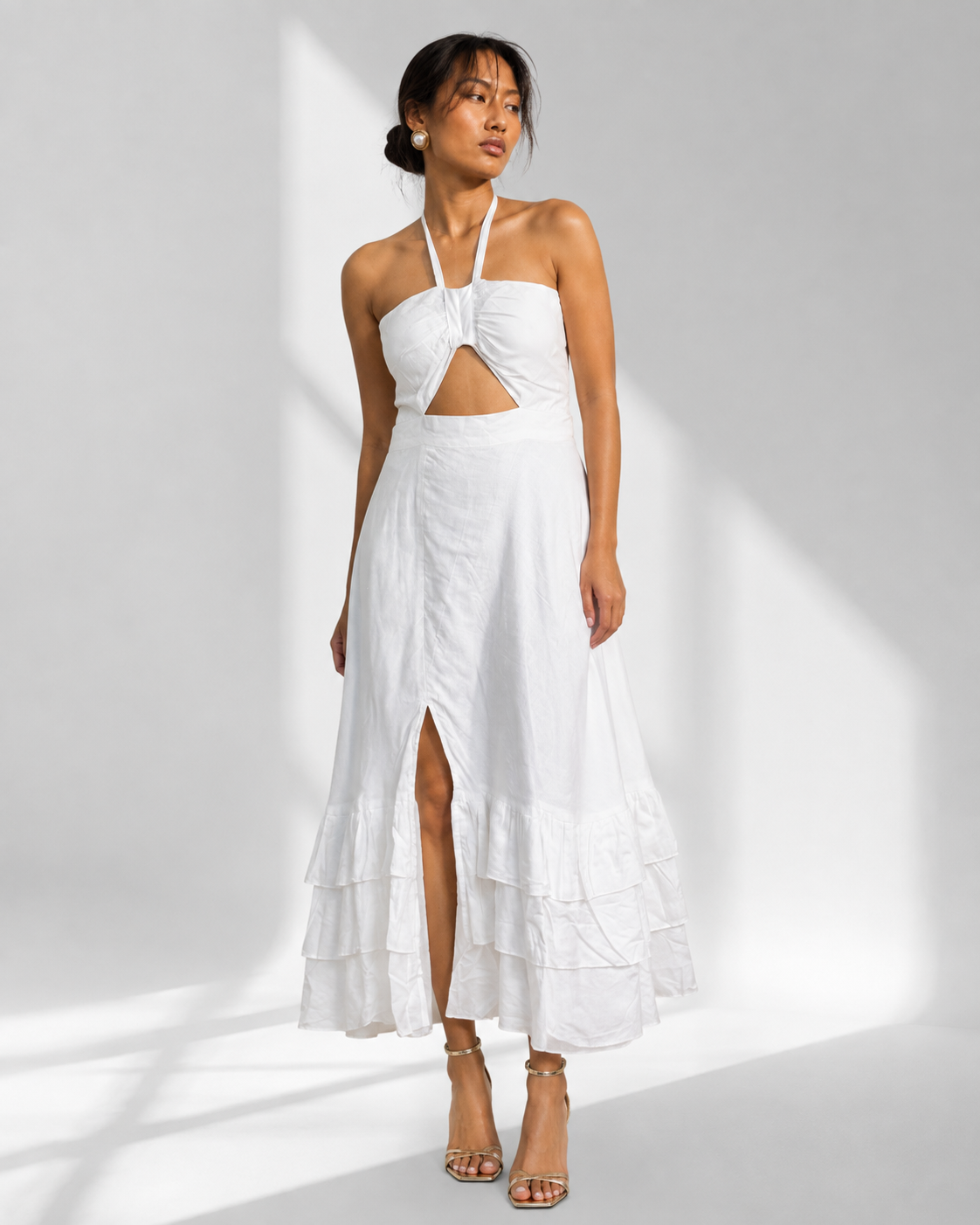 Neha Sharma Label MAREVA white halter maxi dress with keyhole cutout and front slit, front view.