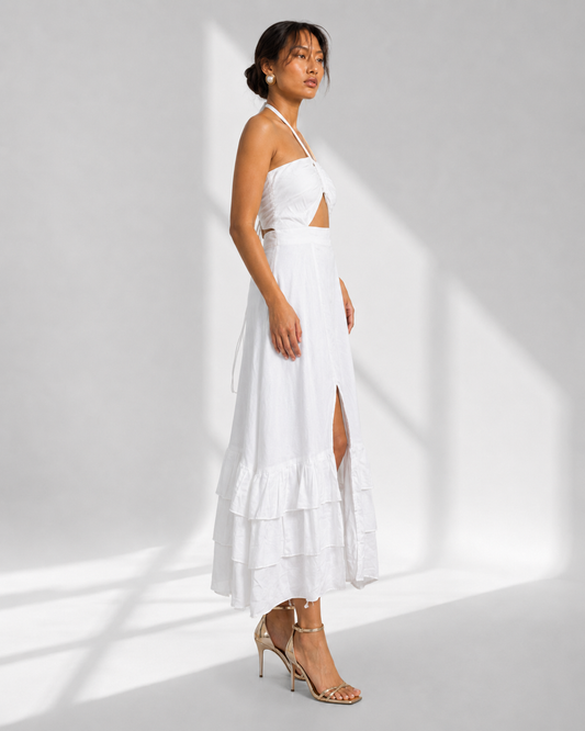 MAREVA white halter cutout maxi dress in profile with triple ruffle tiered hem.