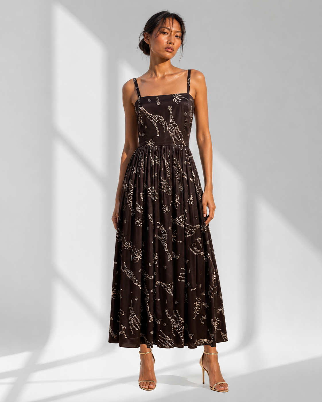 Neha Sharma Label NYALA black safari print satin midi dress with square neck, front view on model.