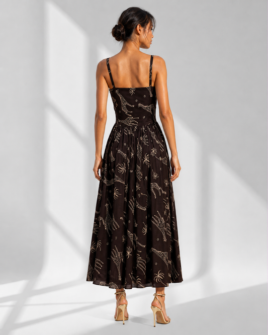 Back view of the NYALA black satin midi dress showing the panelled bodice and gathered skirt.