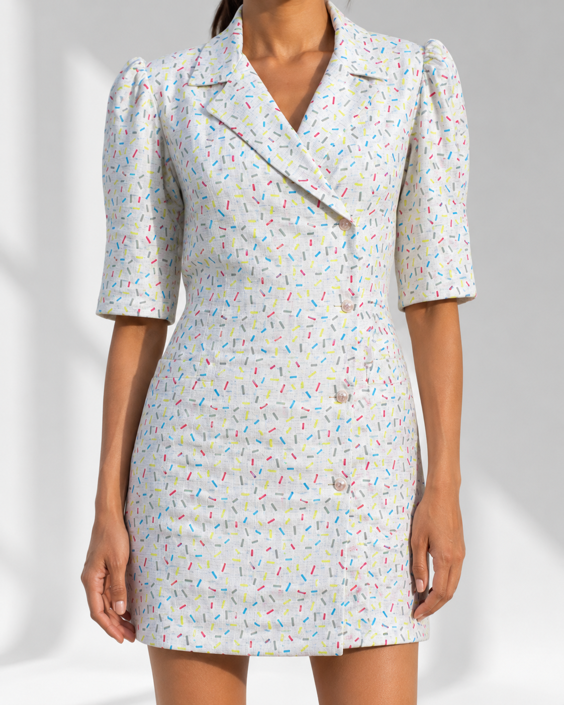Close view of the offset buttons, lapels and confetti print on the LUDOVICA blazer dress.